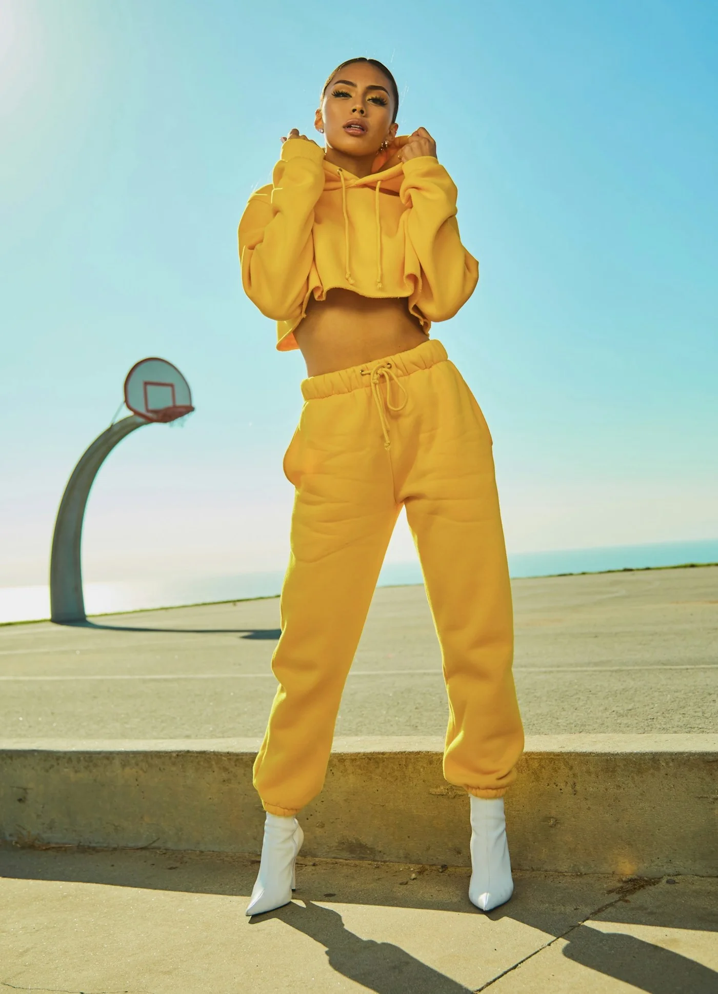 Yellow coordinated outfit beside an outdoor basketball court
