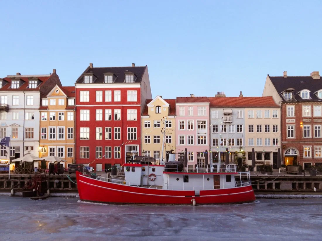 Colorful buildings and a red boat at Nyhavn in Copenhagen