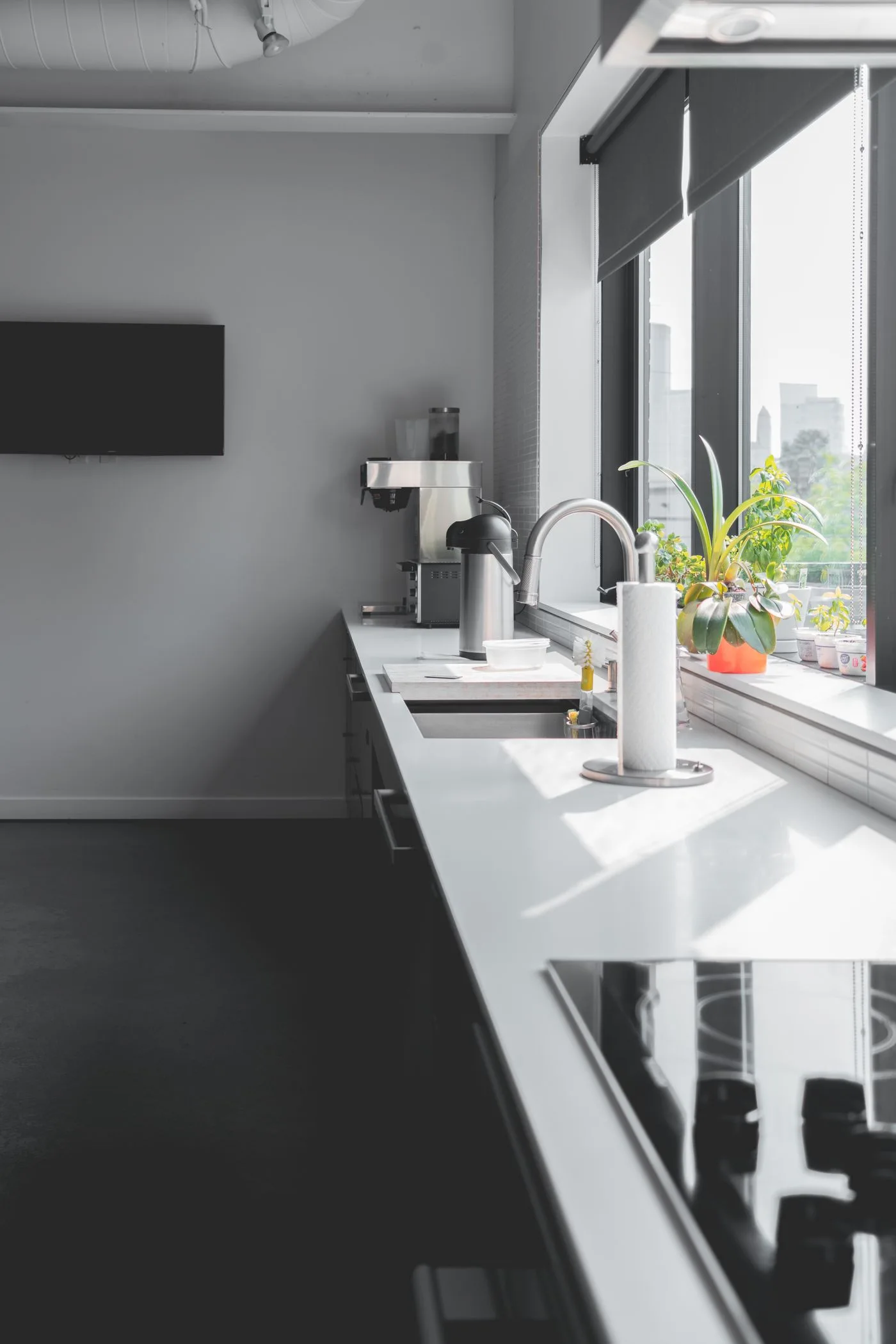 A bright kitchen counter beside large windows.