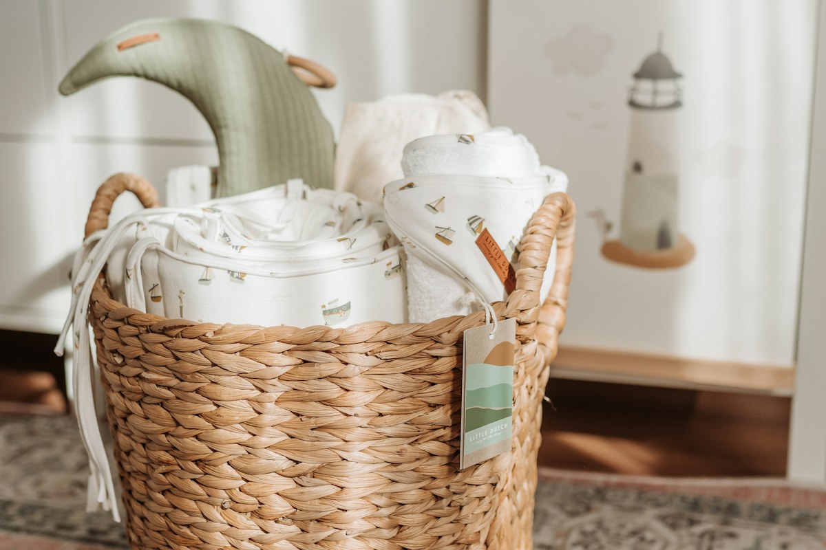 Woven basket holding a pale teapot and cups