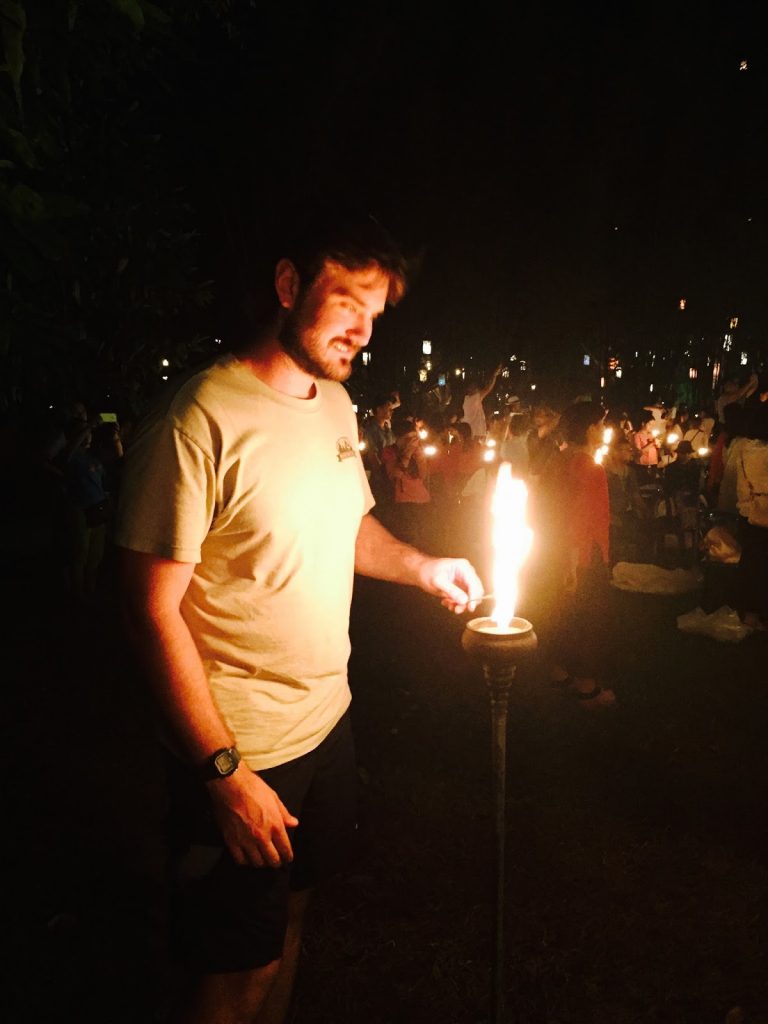 lighting the lantern at Yi Peng